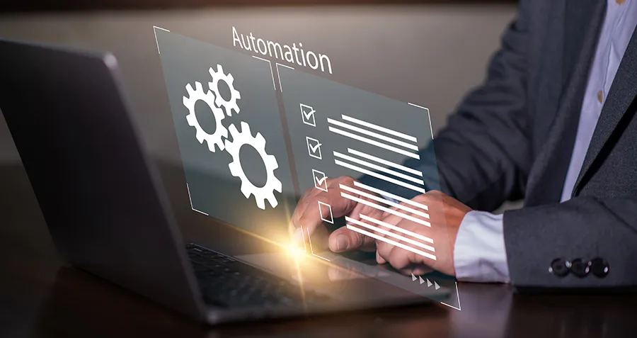 business professional using business automation tools on a laptop with digital workflow icons