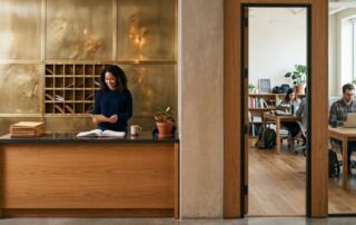 virtual office or coworking desk: which one do you actually need? 2 virtual office vs coworking in one frame: reception and mail slots on one side, coworking desks on the other